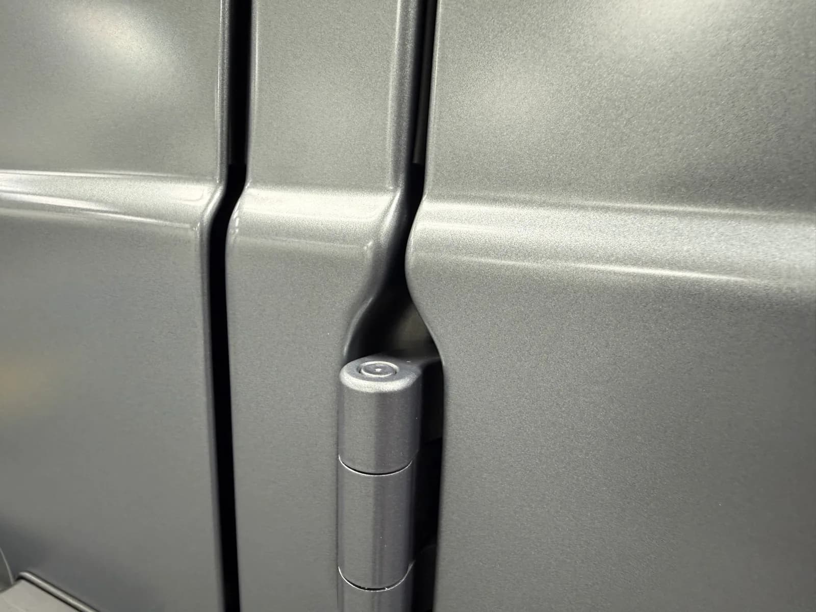 Close-up of a Brabus G-Class door gap at the hinge, with paint protection film wrapped around both panel edges into the gap